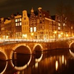 Amsterdam de grachten avonds verlicht.